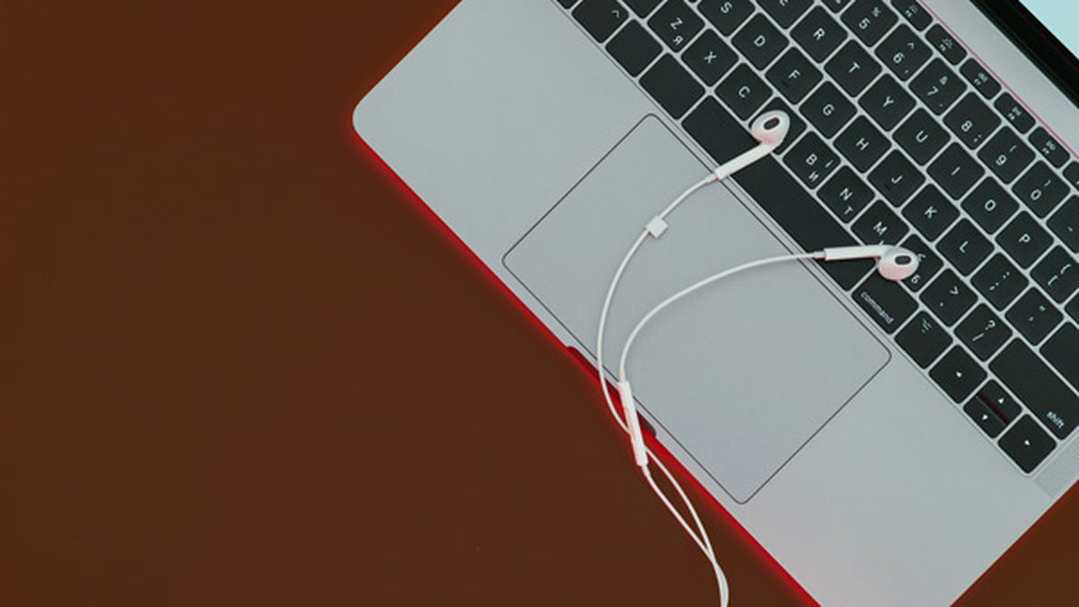 MacBook with EarPods resting on the trackpad